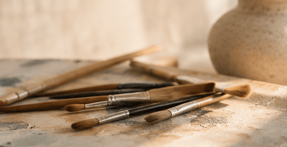Paintbrushes arranged on an artist table